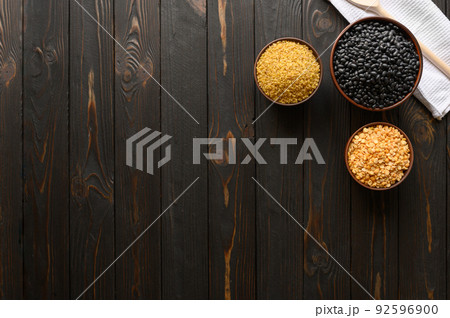 Different type of composition of raw dry legumes and cereals. Black beans, bulgur, peas. Different type of composition of raw dry legumes and cereals. Black beans, bulgur, peas. 92596900