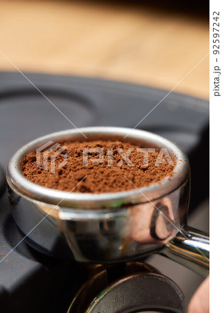 Asian man coffee shop part time employee brew hot coffee in coffee machine. Male barista hand making espresso from ground coffee maker at modern cafe. Small business and part time job working concept. Asian man coffee shop part time employee brew hot coffee in coffee machine. Male barista hand making espresso from ground coffee maker at modern cafe. Small business and part time job working concept. 92597242
