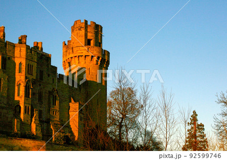 Ancient European medieval architectural building castle in golden autumn light with the blue sky background during autumn 92599746