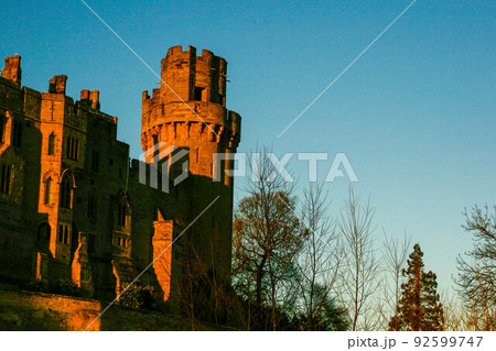 Ancient European medieval architectural building castle in golden autumn light with the blue sky background during autumn 92599747