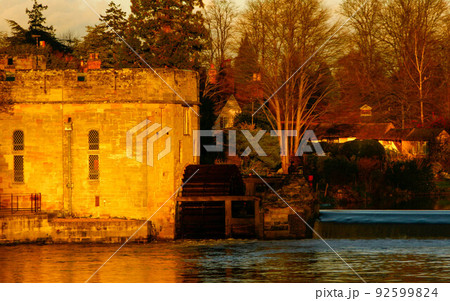 Ancient European medieval architectural building castle in golden autumn light with the blue sky background during autumn 92599824