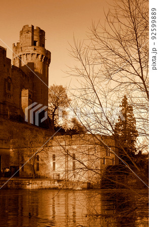 Ancient European medieval architectural building castle in golden autumn light with the blue sky background during autumn Ancient European medieval architectural building castle in golden autumn light with the blue sky background during autumn 92599889