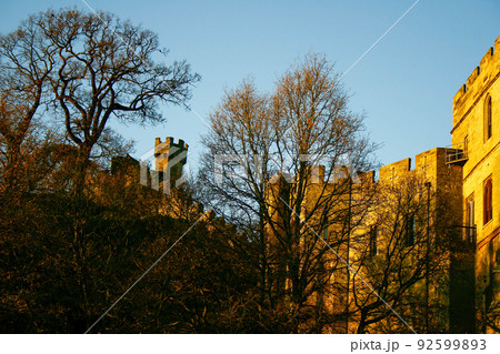 Ancient European medieval architectural building castle in golden autumn light with the blue sky background during autumn 92599893