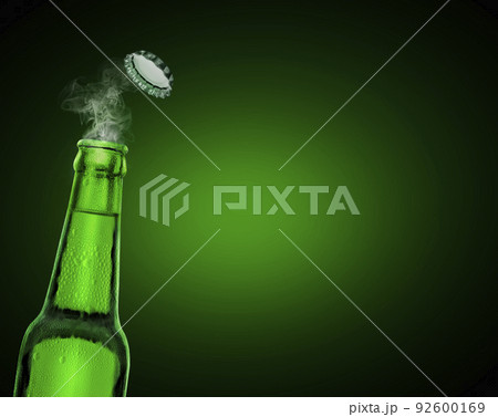cold wet open beer bottle with smoke on green background cold wet open beer bottle with smoke on green background 92600169