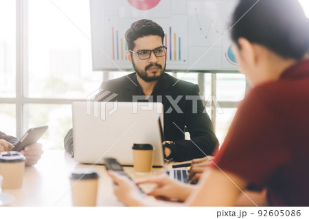 Business man with beard using laptop sitting and discussion strategy with team in boardroom 92605086