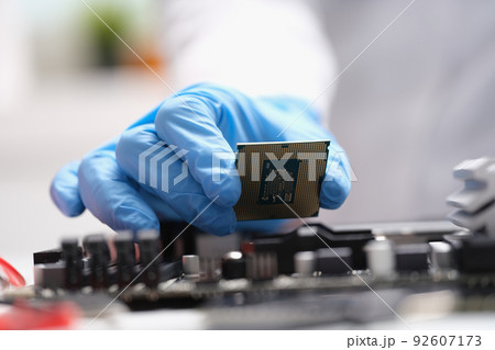 Computer engineers hand is holding cpu processor 92607173