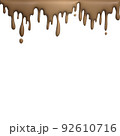 melted chocolate dripping on white background 92610716