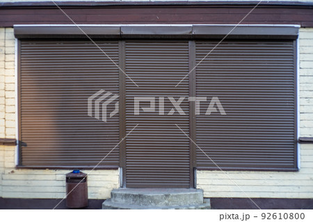 the shop window is closed with iron shutters. Bankrupt during the crisis. 92610800