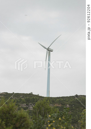 Wind turbines. Windmill in motion generating clean and renewable energy on a cloudy day, in Spain. Europe. Photography. Wind turbines. Windmill in motion generating clean and renewable energy on a cloudy day, in Spain. Europe. Photography. 92612204