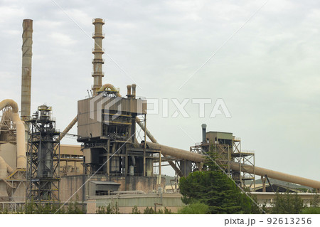 Factory. Cement factory seen from the outside on a cloudy day, in Spain. Europe. Horizontal photography. 92613256