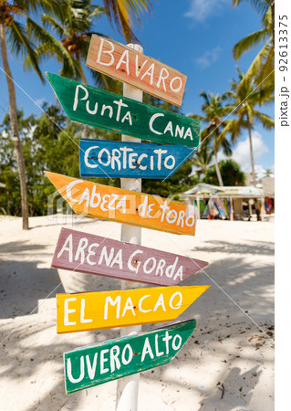 07.24.2022. Dominican Republic Bavaro Punta cana provinces La Altagracia. Wooden pillar with signposts directions 92613375