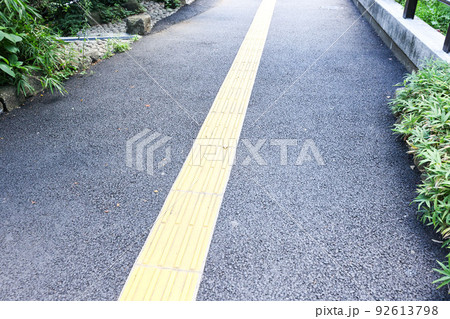 夏、炎天下に街と点字ブロックと歩道 92613798