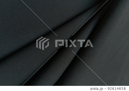 Gray crumpled or wavy fabric texture background. Abstract linen cloth soft waves. Gabardine wool fabric. Merino yarn. Smooth elegant luxury cloth texture. Concept for banner or advertisement. 92614658