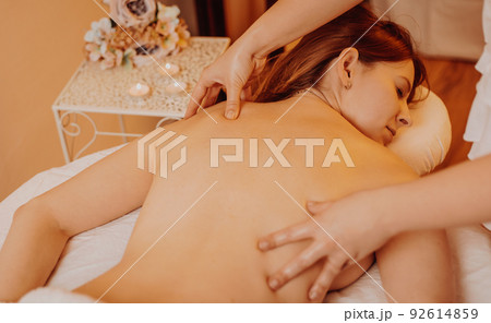 Pretty young woman during body massage in the studio, relax time concept 92614859