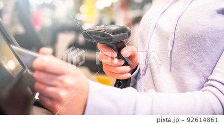 Young woman hands scanning, entering discount, sale on receipt, touch screen cash register, market, shop, finance concept 92614861