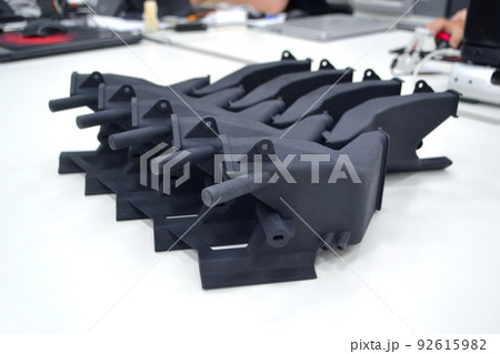 Black model printed on 3D printer in laboratory office. Object printed on 3D printer from plastic close-up. Prototype made on 3d printer. Concept new modern printing technology. Multi Jet Fusion Black model printed on 3D printer in laboratory office. Object printed on 3D printer from plastic close-up. Prototype made on 3d printer. Concept new modern printing technology. Multi Jet Fusion 92615982