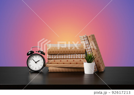 Education concept with stack of books on a table against colored background. Education concept with stack of books on a table against colored background. 92617213