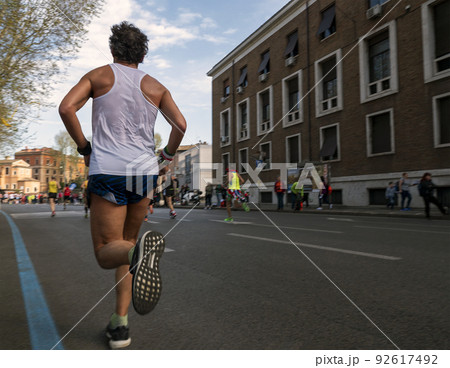 male runner running marathon race in rome male runner running marathon race in rome 92617492