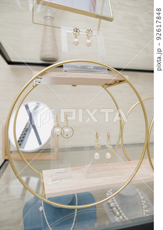Shop window with necklaces and jewelry. Custome jewelry on display Shop window with necklaces and jewelry. Custome jewelry on display 92617848