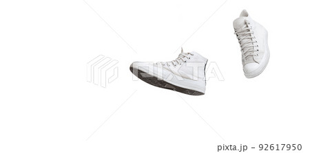 Casual, stylish, white gumshoes, sneakers isolated over white studio background. Flyer 92617950