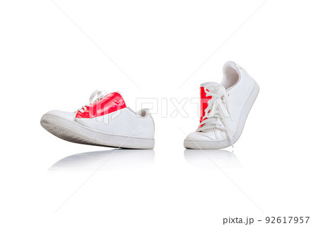 Casual, stylish, white gumshoes, sneakers with red design element isolated over white studio background 92617957