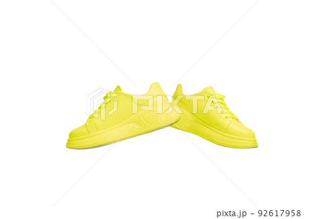 Stylish, trendy, colorful yellow gumshoes, sneakers isolated over white studio background 92617958