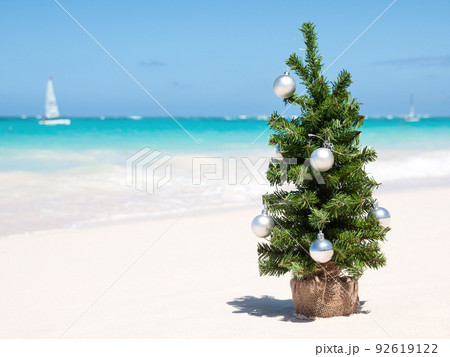 Christmas fir tree on sandy beach. Tropical New year celebration 92619122