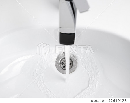Water running from Faucet tap in white sink 92619123