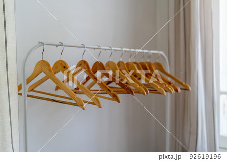 Close-up of wardrobe with wooden clothes hanger, 92619196