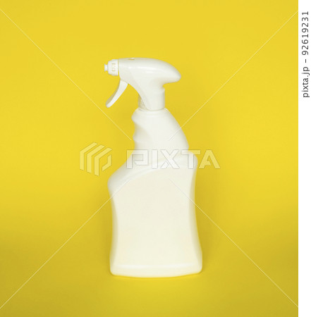 White plastic spray bottle for liquid cleaning products isolated on yellow background. Packaging mockup bottle with sprayer. White plastic spray bottle for liquid cleaning products isolated on yellow background. Packaging mockup bottle with sprayer. 92619231