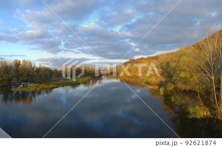 Sunrise in autumn by the lake, lake in the backlight of the rising sun, park in autumn and autumn leave in the sunlight in the morning, colorful leaves on the water, trees in the autumn by the water Sunrise in autumn by the lake, lake in the backlight of the rising sun, park in autumn and autumn leave in the sunlight in the morning, colorful leaves on the water, trees in the autumn by the water 92621874