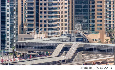 Futuristic building of Dubai tram station and luxury skyscrapers behind in Dubai Marina aerial timelapse, United Arab Emirates 92622213