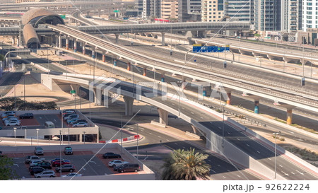Futuristic building of Dubai metro station and luxury skyscrapers behind in Dubai Marina aerial timelapse, United Arab Emirates Futuristic building of Dubai metro station and luxury skyscrapers behind in Dubai Marina aerial timelapse, United Arab Emirates 92622224