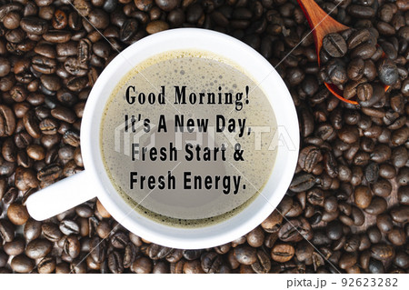 Motivational quote on cup of coffee on coffee beans background. 92623282