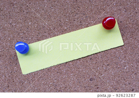Yellow stick note and pinned to a cork notice board. Copy space. Yellow stick note and pinned to a cork notice board. Copy space. 92623287