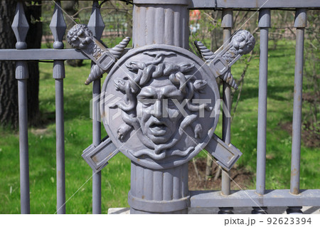 fence decor - face of Gorgon Medusa, monster with female face and snakes instead of hair. 92623394