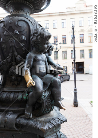 Sculpture of a child on a lamppost. His hand is lighter, tourists will rub it for good luck. Sculpture of a child on a lamppost. His hand is lighter, tourists will rub it for good luck. 92623395