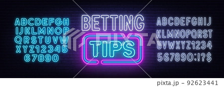Betting tips neon sign on a brick background. 92623441