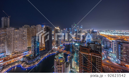 View of various skyscrapers in tallest recidential block in Dubai Marina aerial night timelapse 92623542