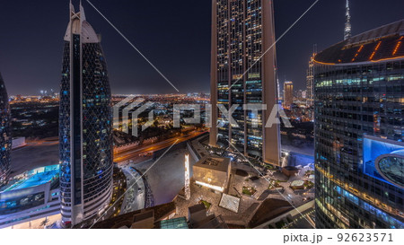 Aerial view of Dubai International Financial District with many skyscrapers night timelapse. 92623571