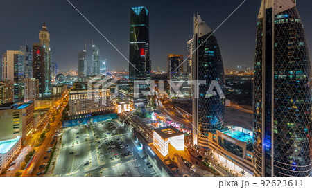Aerial view of Dubai International Financial District with many skyscrapers night timelapse. 92623611