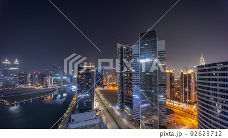 Cityscape of skyscrapers in Dubai Business Bay with water canal aerial all night timelapse Cityscape of skyscrapers in Dubai Business Bay with water canal aerial all night timelapse 92623712