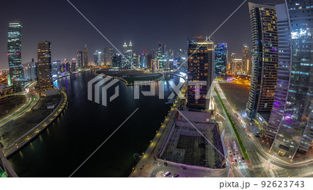 Cityscape panorama of skyscrapers in Dubai Business Bay with water canal aerial night timelapse 92623743