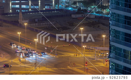Bussy traffic on the road intersection in Dubai business bay district aerial night timelapse, UAE 92623793