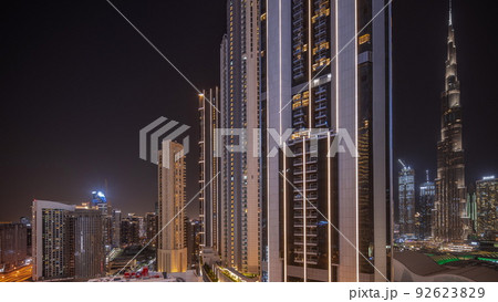 Tallest skyscrapers in downtown dubai located on bouleward street near shopping mall aerial night timelapse. 92623829