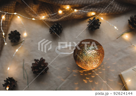 Christmas composition on craft paper background with gift box, fir branches, toys, copy space for your congratulations 92624144
