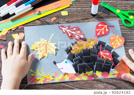 Autumnal application of a hedgehog and deciduous leaves. Children's Art Project, needlework, crafts for kids. Autumnal application of a hedgehog and deciduous leaves. Children's Art Project, needlework, crafts for kids. 92624192