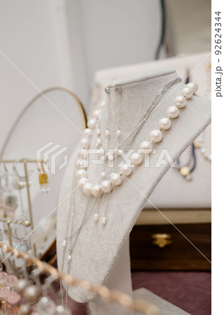 Shop window with necklaces and jewelry. Custome jewelry on display Shop window with necklaces and jewelry. Custome jewelry on display 92624344