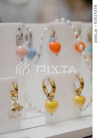 Shop window with necklaces and jewelry. Custome jewelry on display Shop window with necklaces and jewelry. Custome jewelry on display 92624356