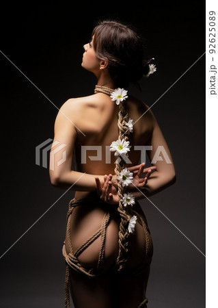 Unrecognizable naked woman tied with ropes 92625089